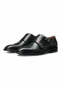 Svarta läder dubbel monk strap-skor med en slät yta, rund tå och metalspännen på remmarna för säker stängning.