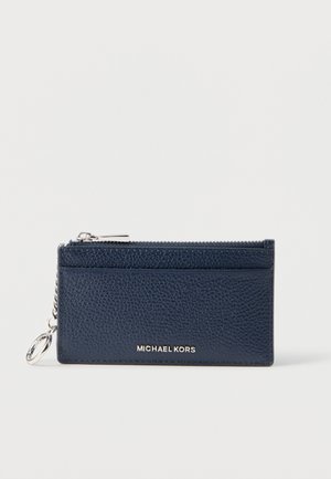 Navy blue textured leather card holder with a silver zipper and keychain. Features a logo and slots for cards on one side.