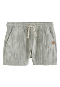 Pantaloncini in cotone grigio chiaro con un design testurizzato e leggermente stropicciato. Presentano una vita elasticizzata con coulisse e tasche laterali. Dettaglio con etichetta in pelle marrone.
