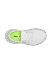 White running shoe with a mesh upper, reflective accents, and a bright green insole. Features a rounded toe and a cushioned sole.