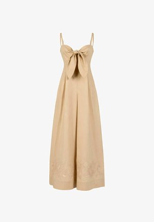 Tuta beige senza maniche a gamba larga con dettaglio nodo frontale e ricamo floreale lungo l’orlo.