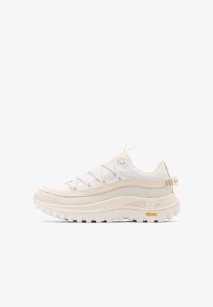 Off-white hiking-style sneaker with thick textured sole, loop pull tab at heel and tongue, and detailed lace-up fastening.