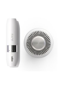 Appareil facial en plastique blanc avec une bande argentée et des icônes de contrôle ; la base circulaire présente des pales de ventilateur métalliques et un centre lisse.