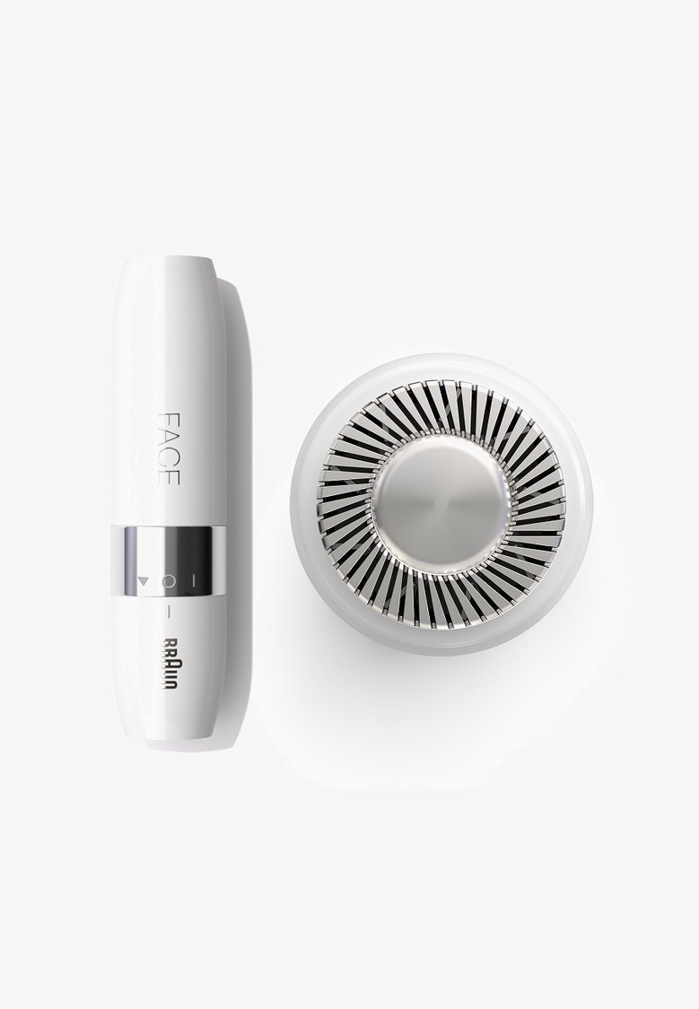 Appareil facial en plastique blanc avec une bande argentée et des icônes de contrôle ; la base circulaire présente des pales de ventilateur métalliques et un centre lisse.