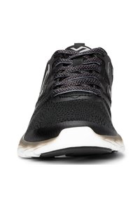 Black athletic shoes with a mesh upper, round toe, and textured laces. White midsole and black textured outsole with subtle branding on the sides.