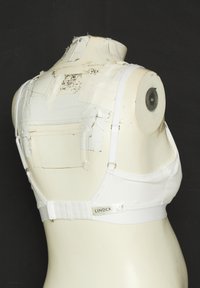 White bra made of smooth fabric, featuring adjustable straps and a hook-and-eye closure at the back. Labeled "Lindex" on the band.