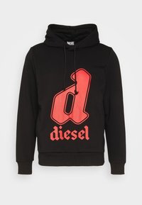Svart hoodie i bomull med ett stort rött grafiskt bokstav "d" och ordet "diesel" i fet stil. Har dragsko.
