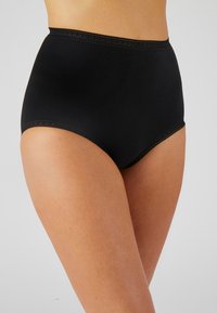 Mutande nere a vita alta realizzate in un tessuto morbido, con pizzo lungo il girovita e un design senza cuciture per il massimo comfort.