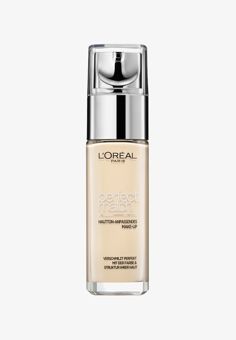 L'Oréal Paris Perfect Match foundation i en klar glasflaske med en sølv pumpe. Lys beige væske, mærket med hvid og sort tekst.