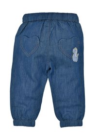 Jeanshose mit elastischem Bund, ausgestattet mit herzförmigen Taschen und einem kleinen gestickten Motiv eines Wesens auf der rechten Tasche.