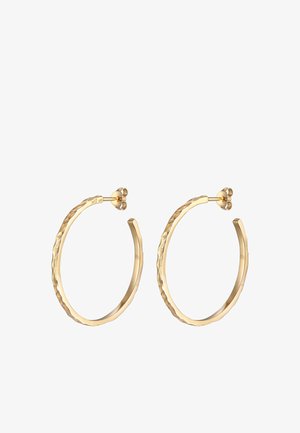 Boucles d'oreilles en or avec une surface texturée, dotées d'une fermeture ronde. La forme générale est circulaire avec un léger design torsadé.