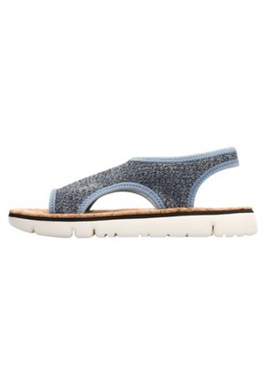 Blue-patterned sandal with a textured fabric upper, open design, and a light-colored cork footbed. Thick white rubber sole.