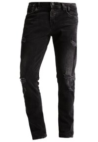 Svarta jeans i denim med slim fit, som har slitna områden och en klassisk fem-fickorsdesign. Tyget har en lätt blekning och en mjuk textur.