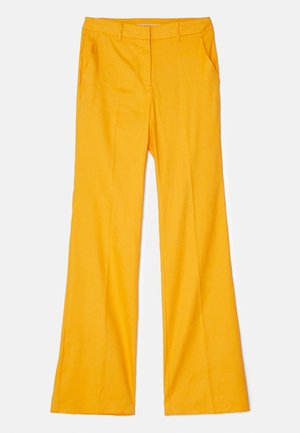 Yellow flared trousers made from a smooth fabric, featuring front pockets and a flat front, with a regular waistband design.