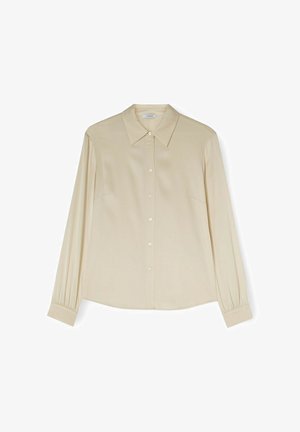 Beige pitkähihaine nappipaitapusero, jossa on terävä kaulus ja kerätyt hihansuut, esitelty tasaisena valkoisella taustalla.