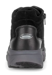 Black suede ankle boot with synthetic accents, features a zipper, padded collar, and a thick, textured gray sole. Logo on heel.
