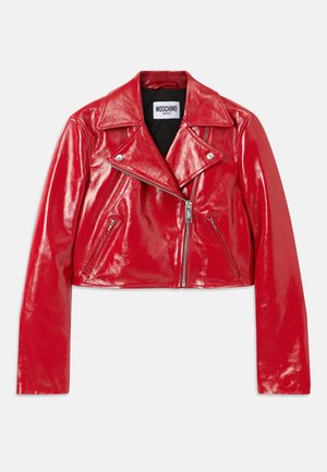 Raudona blizgi, trumpa odinė striukė su įpjovimu ant apykaklės, asimetriška užtrauktuko sistema ir šoninėmis kišenėmis. Papuošta sidabrinėmis detalėmis.