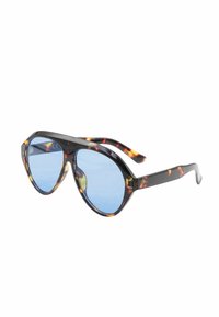 Occhiali da sole tartaruga con lenti blu, caratterizzati da un design rotondo e oversize e una robusta montatura in plastica con texture liscia.