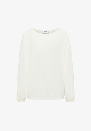Long-sleeve white blouse with round neckline, small front keyhole and button detail, elastic hem, and cuffed sleeves.