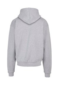 Grauer Kapuzenpullover aus weichem Baumwoll-Mix-Gewebe. Mit einer Kängurutasche, gerippten Bündchen und einer Kordelzugkapuze. Klassischer, lockerer Schnitt.