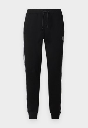 Zwarte sweatpants met een relaxte pasvorm, elastische tailleband, trekkoord, zijzakken en witte zijstrepen met merkaccenten.