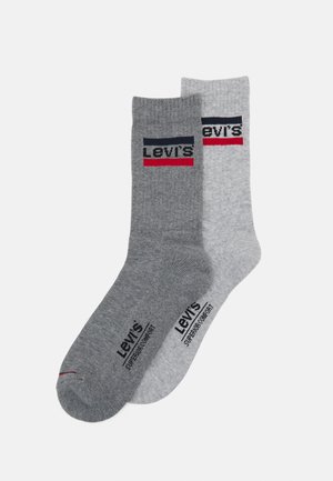 Levi's socks in two shades of grey. One features a dark band with red and navy accents; both have logo text and soft cotton texture.