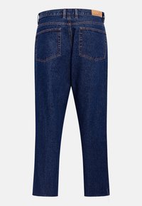 Dark blue denim jeans with a slightly tapered leg, accented with orange stitching and two back pockets. Features a leather waist label.