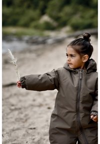Brown insulated jacket with a hood, featuring elastic cuffs and a front zipper. Child holding a decorative white plant stem.