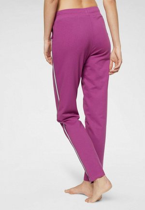 Lila Jogginghose aus weichem Material, mit seitlichen Streifen, schmal zulaufenden Beinen und einem elastischen Bund für Komfort.