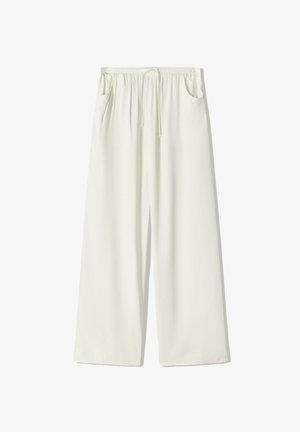 Løse hvide bukser med elastisk taljebånd, snøre og sidelommer, designet til casual brug.