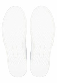 White rubber shoe soles with a herringbone tread pattern, featuring flat, smooth edges and a brand logo on the center of each sole.
