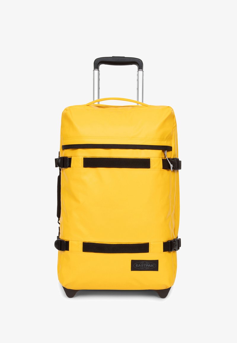 Gul resväska på hjul med ett robust handtag, svarta remakzentuer och en slät, slitstark yta. Innehåller logotypstryka på framsidan.