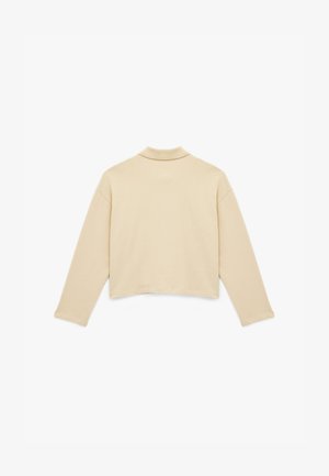 Vaaleanbeige lyhyt muotoinen collegepaita, jossa on pitkät hihat ja laskettavat kaulukset. Sileä pinta ja minimalistinen muotoilu, esitetty takaa.