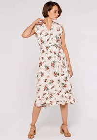 Floral wrap dress in light fabric with a v-neck, ruffled sleeves, and waist tie. It features a cream background with red and green floral patterns.