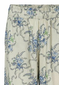 Pantalons en tissu léger avec un fond beige, ornés d'un motif floral bleu et vert, dotés d'une taille élastique pour plus de confort.