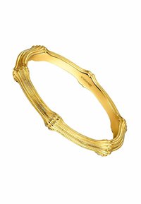 Pulsera de oro con un diseño texturizado que presenta segmentos alargados que se asemejan a huesos. Superficie interior lisa con grabado de la marca.