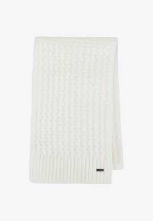 Couverture crème tricotée avec un motif texturé, bords côtelés et une petite étiquette de marque. Design doux, confortable et léger.