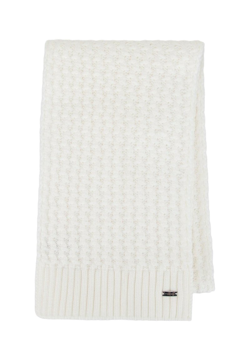 Coperta cremè lavorata a maglia con motivo testurizzato, bordi a coste e una piccola etichetta con marchio. Design morbido, accogliente e leggero.