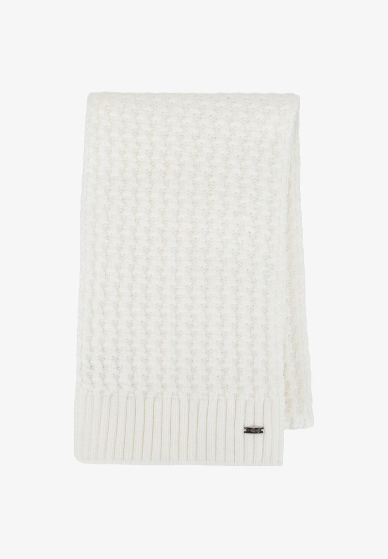 Coperta cremè lavorata a maglia con motivo testurizzato, bordi a coste e una piccola etichetta con marchio. Design morbido, accogliente e leggero.