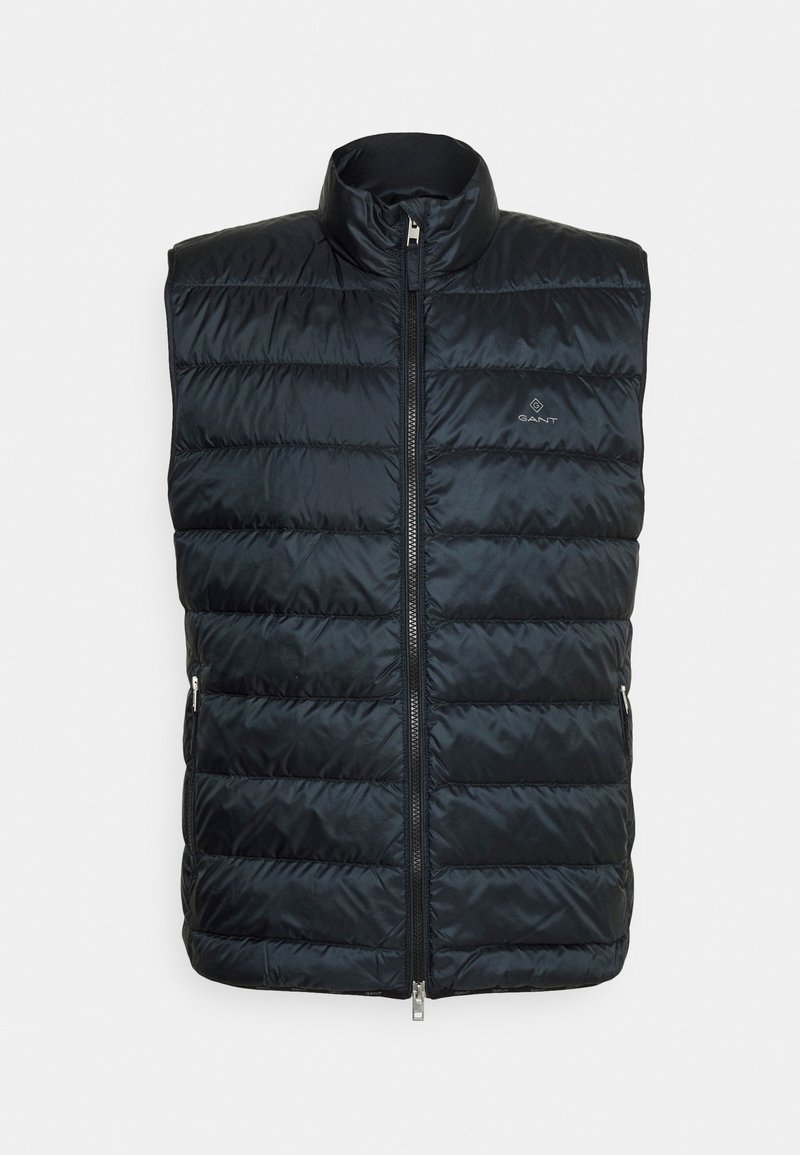 Veste sans manches matelassée noire avec fermeture éclair sur le devant et petit logo sur la poitrine gauche, col montant, deux poches latérales zippées.