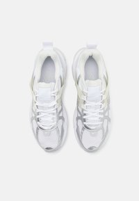 White mesh and synthetic sneakers feature silver accents, round toe, padded collar, and laces. Designed for comfort and breathability.