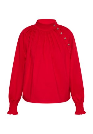 Bluză roșie cu mâneci lungi și guler înalt, având detalii pliate și trei butoane Decorative pe umărul stâng. Mansete texturate.