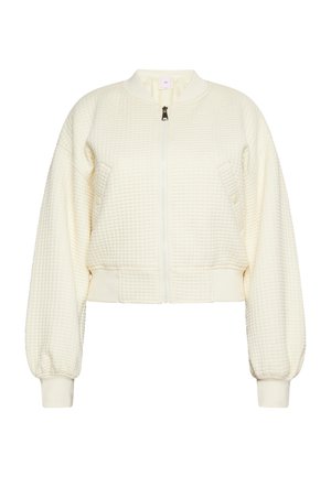 Rövidített krémszínű dzseki texturált goffrázott mintával, cipzáras elülső záródással, bordázott mandzsetta- és gallérrésszel. Két elülső zseb, puha anyag.