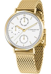 Orologio da polso in rete dorata con quadrante bianco, dotato di indici delle ore, tre sub-quadranti e una corona. Nome del marchio "LIEBESKIND" visibile.