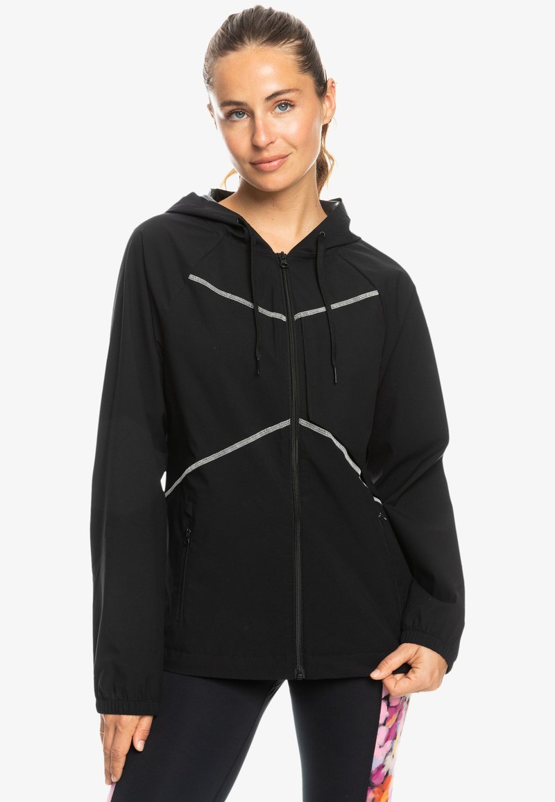 Black hooded jacket made of lightweight material. Features reflective accents, a front zipper, and two side pockets.