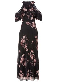 Svart maxiklänning med genomskinliga kallaxelärmar, med ett blomstertryck i rosa och vitt. Flödande tyg med en figurnära midja.