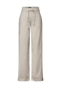 Pantaloni larghi color beige chiaro realizzati in un tessuto liscio e leggermente lucido. Presentano un elastico in vita con cordoncino e una leggera lucentezza.