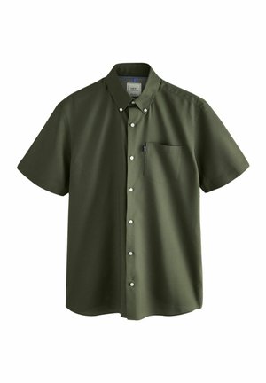 Chemise à manches courtes en coton vert foncé. Dotée d'une poche poitrine et d'une petite étiquette logo, avec des boutons blancs et un col.