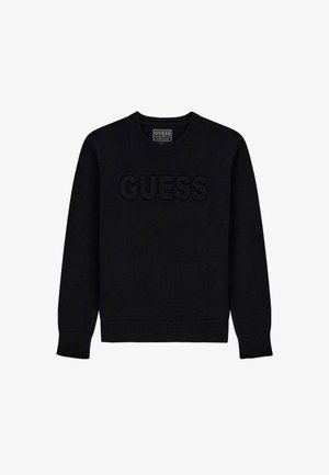 Melnā džemperis ar apaļu kaklu, ar rakstainu "GUESS" logotipu priekšā. Ribota aproce un apakša, izgatavota no mīksta dzijas materiāla.