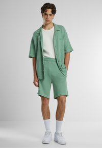 PROHIBITED Tracksuit bottoms - basilgreen